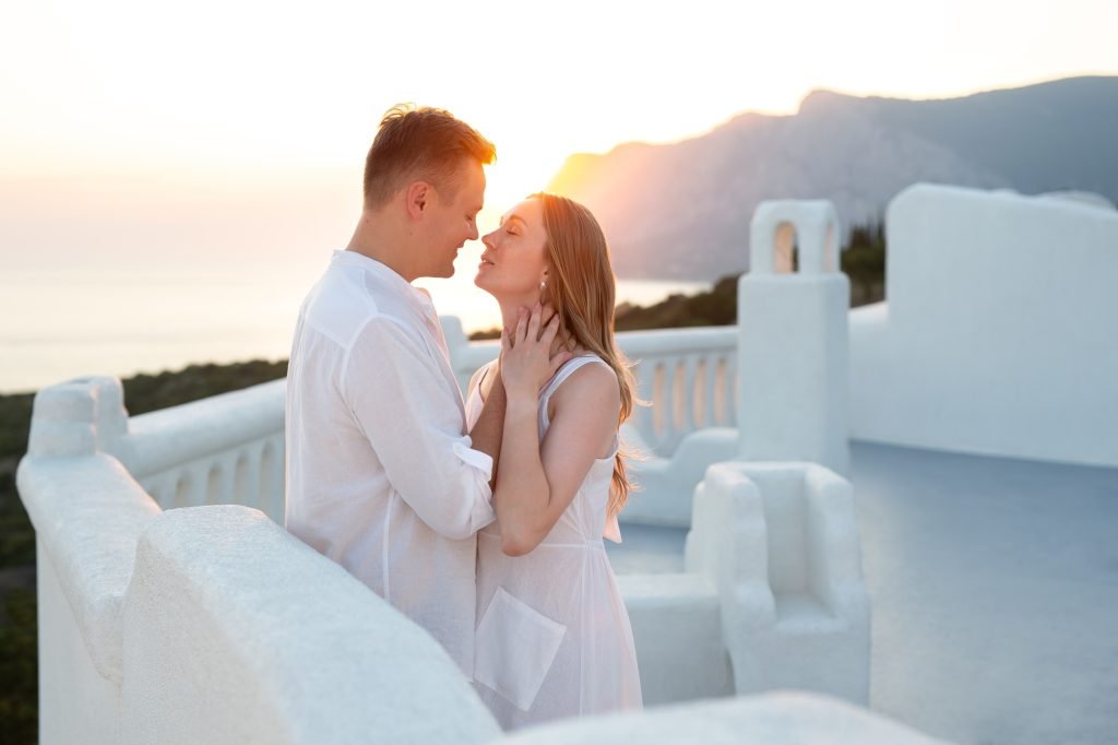 Couple of men and women in love on vacation in Santorini, Greece.