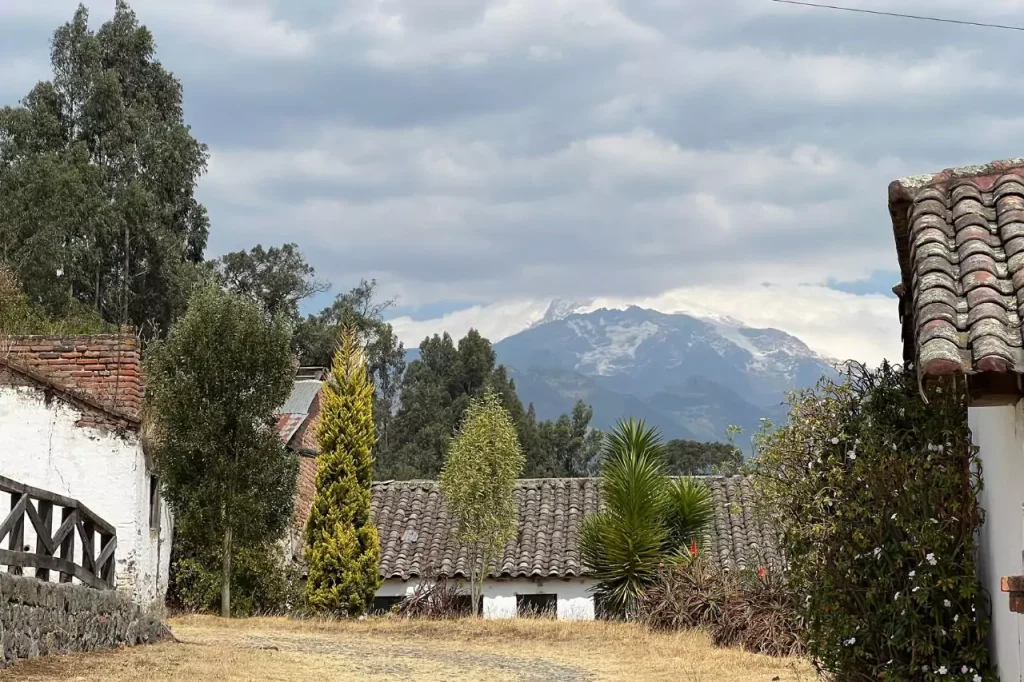 a village with mountains in the background in ecuador