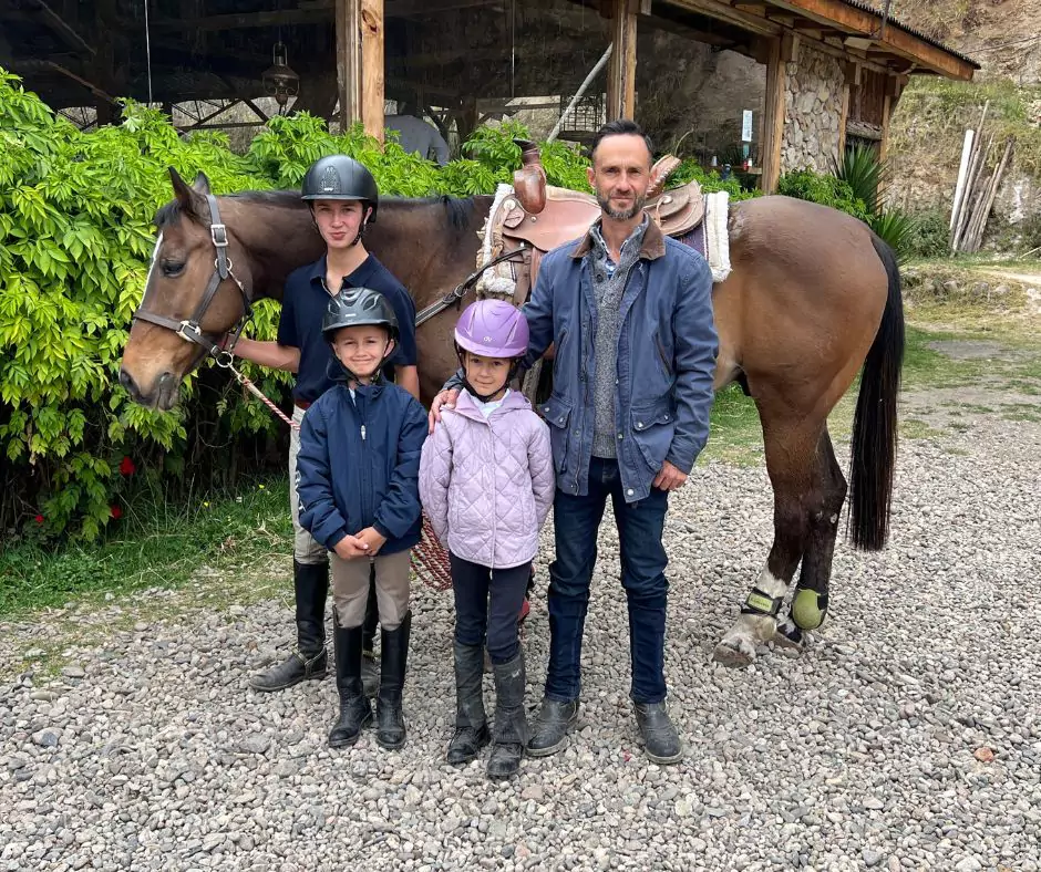 a family posing with a horse