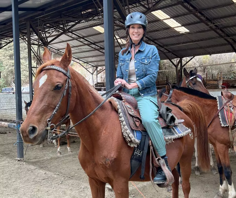 a woman riding a horse