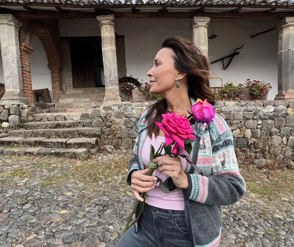 Karen hoding roses at Hacienda El Molino in Ecuador