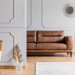Open space living room interior with decorative mirror on wall w