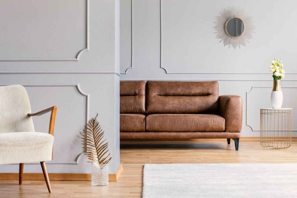 Open space living room interior with decorative mirror on wall w