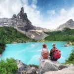 Tourist and Sorapis lake in the Italy. Travel and adventure with team