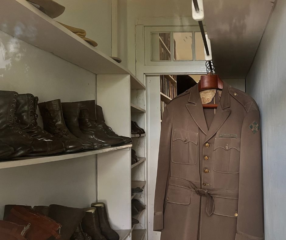 Hemingway’s closet – A neatly arranged collection of boots, hats, and his military uniform hanging inside.