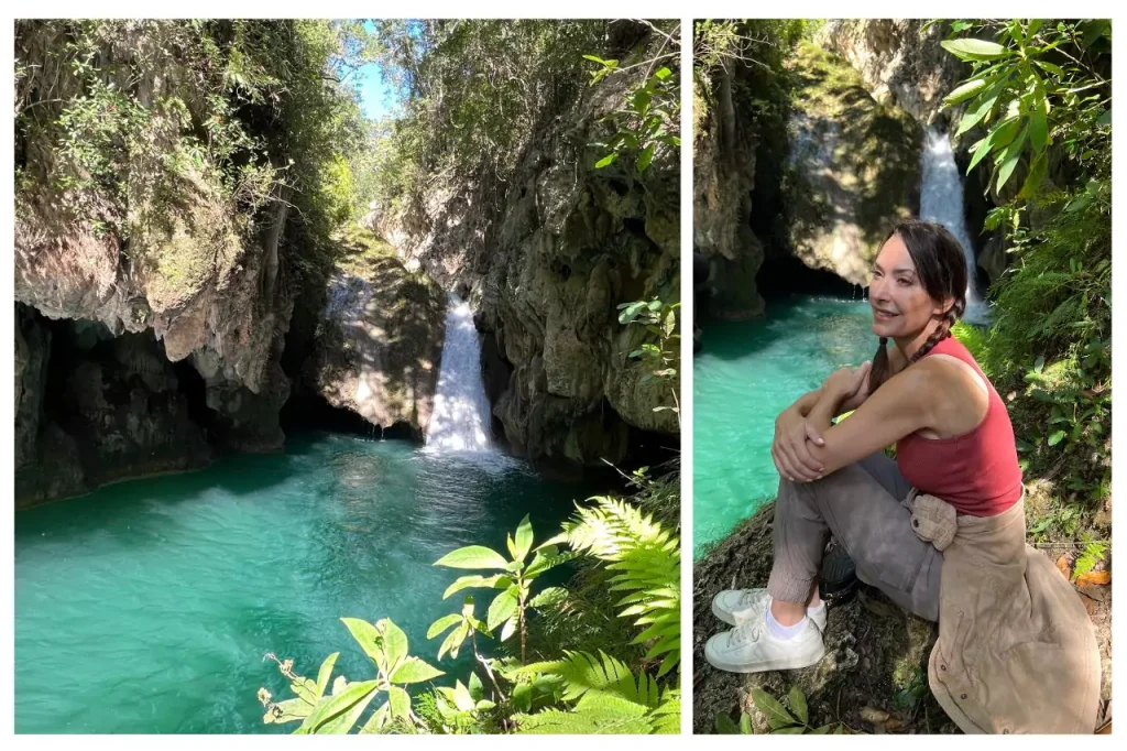 Scenic view of Javira Waterfall surrounded by lush greenery at Topes de Collantes National Park in Cuba, with a woman sitting on a rock admiring the turquoise pool below.