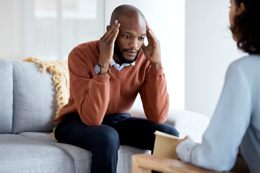 Black man, mental health and therapy with stress headache, psychologist and depression with help. P