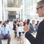 Male speaker speak to diverse business people in a business seminar in a conference room