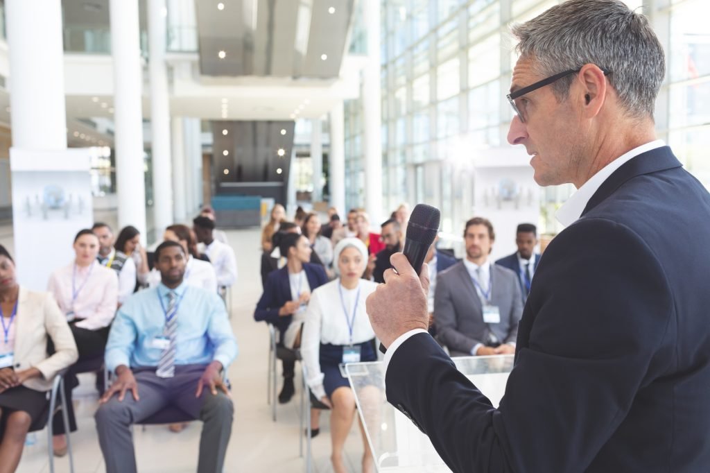 Male speaker speak to diverse business people in a business seminar in a conference room