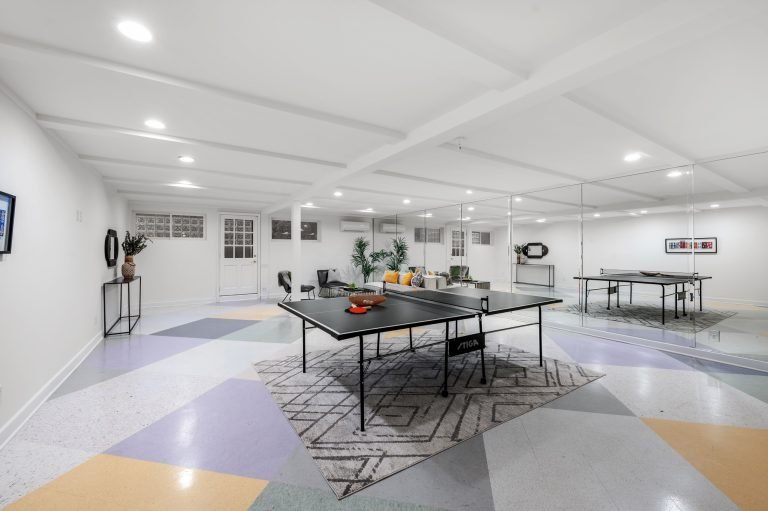 Modern basement game room with ping pong table.