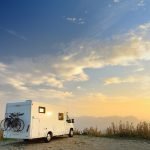Parked big modern camper motorhome. Family vacation travel RV.