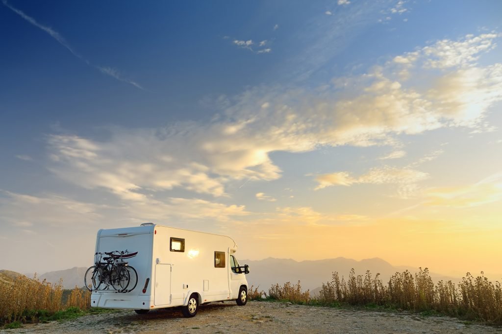 Parked big modern camper motorhome. Family vacation travel RV.