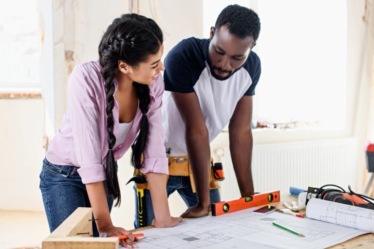 young couple with architecture plan making renovation of home together