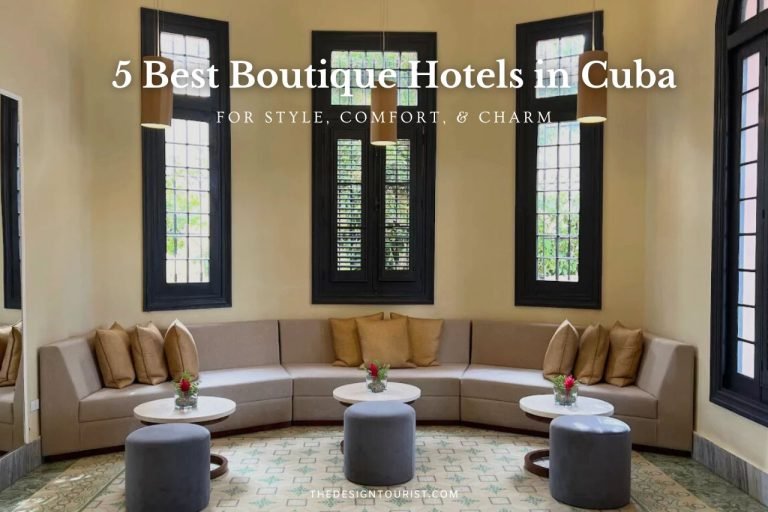 Interior view of VOYA Boutique Hotel in Havana, Cuba—one of the best boutique hotels in Cuba—featuring a stylish lounge with curved sofas, marble tables, and tall windows under soft pendant lighting.