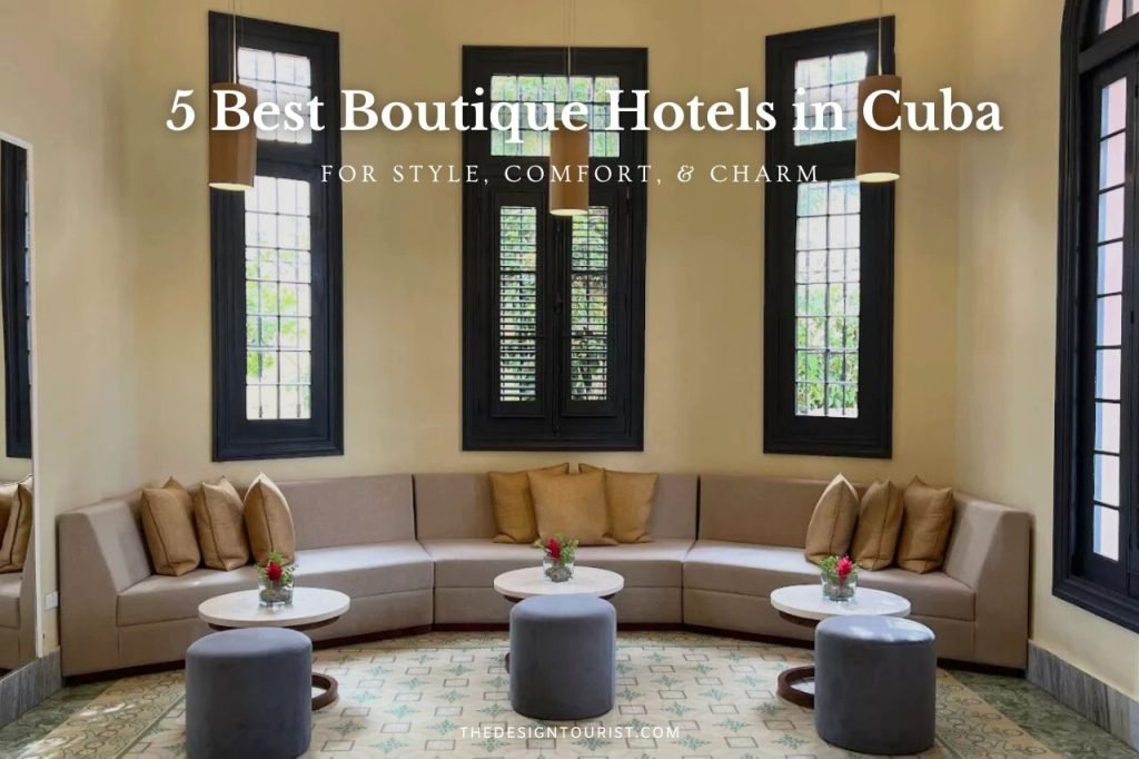 Interior view of VOYA Boutique Hotel in Havana, Cuba—one of the best boutique hotels in Cuba—featuring a stylish lounge with curved sofas, marble tables, and tall windows under soft pendant lighting.