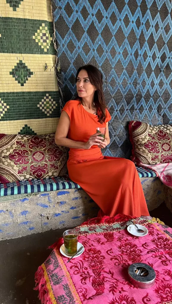 Karen wore an orange casual knit two-piece set while visiting the Berber village of Ourika in Morocco.