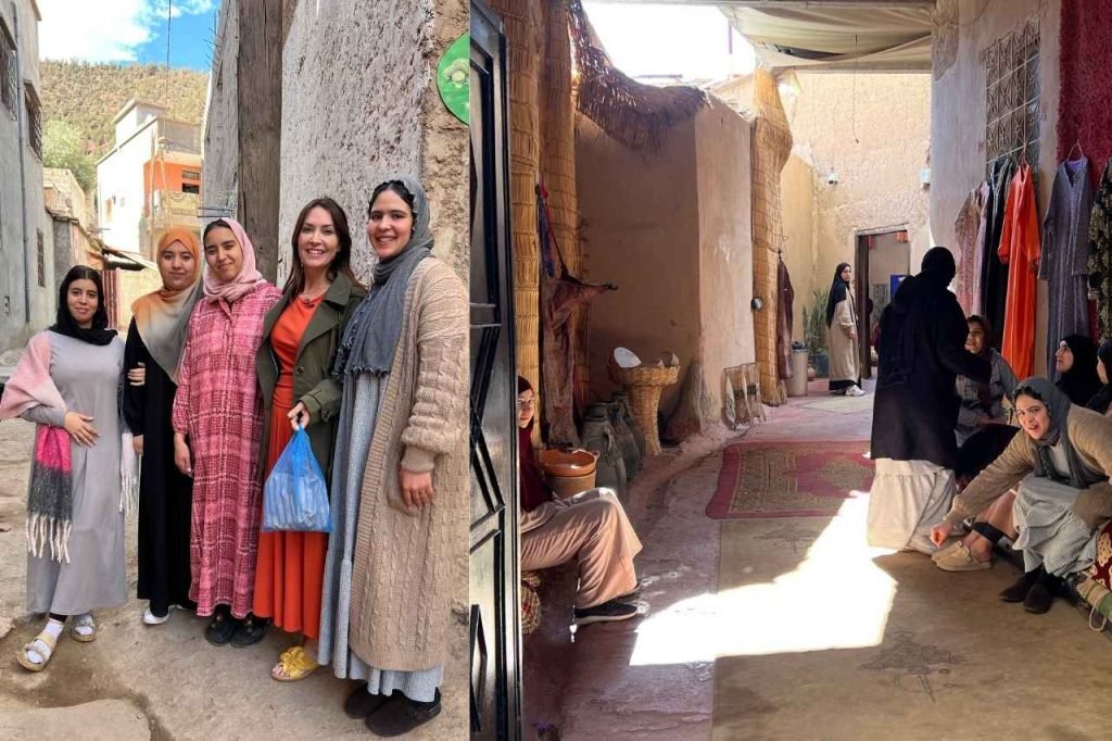 Women from a local Berber cooperative in the Ourika Valley stand together in a village alley, showcasing hospitality and traditional dress. Adjacent is a view of the cooperative's interior, where women sit chatting and working on handmade goods.