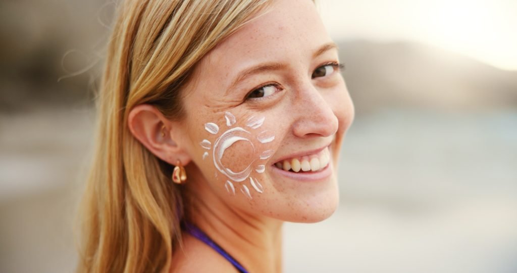 Beach, portrait and woman with sunscreen for skincare, uv protection or beauty at sunset. Ocean, su