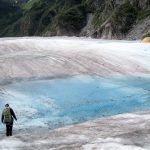 Hikers from behind hiking the amazing Mendenhall Glacier Juneau Alaska USA travel exotic destination