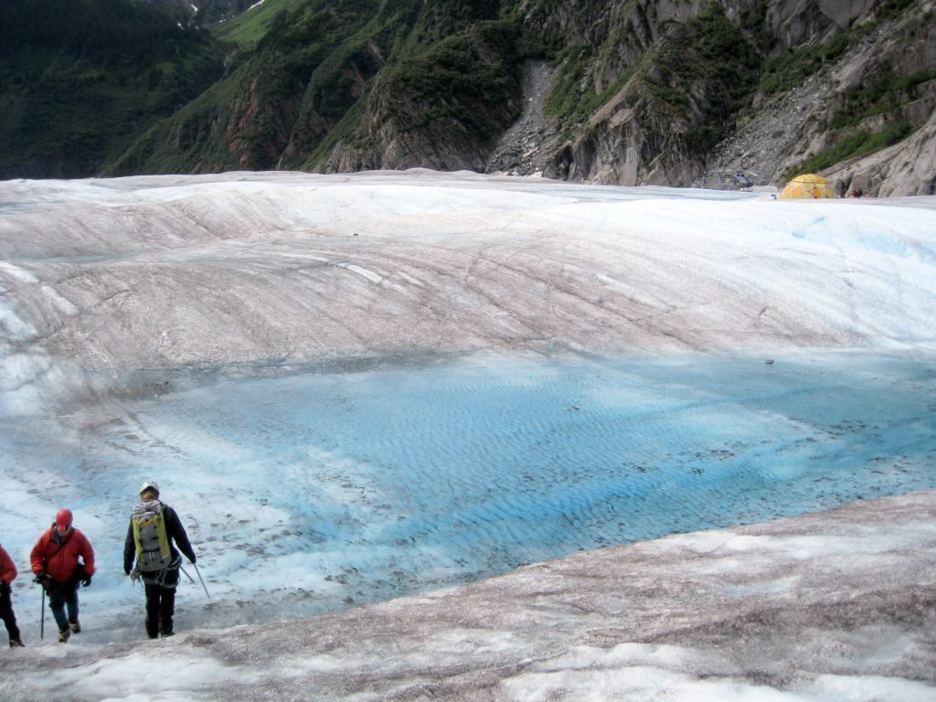 Hikers from behind hiking the amazing Mendenhall Glacier Juneau Alaska USA travel exotic destination
