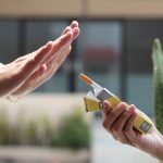 Woman hand refuses a cigarette. Dangerous of smoking