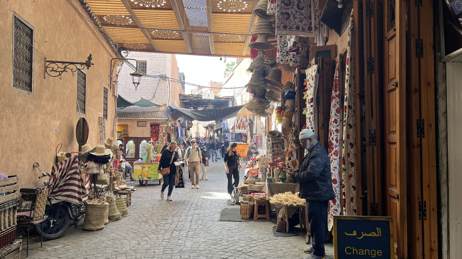 People shopping in a covered alley at Ensemble Artisanal in Marrakech, a curated local market visited during a 2 day in Marrakech shopping itinerary.