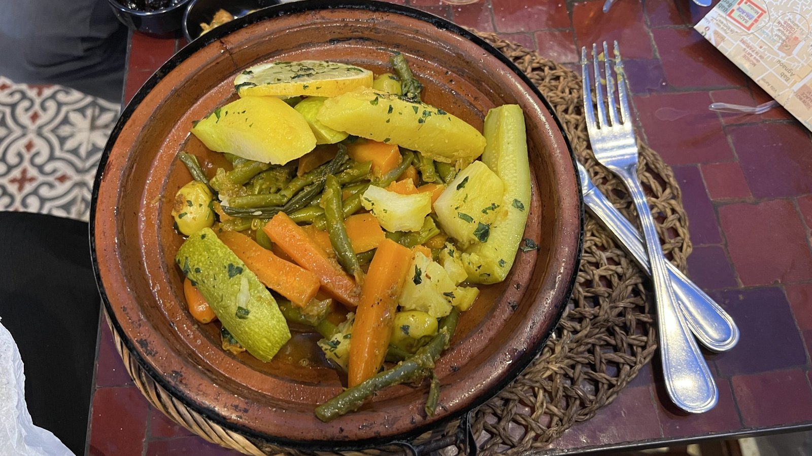 Vegetable tagine served in a traditional clay pot at a local restaurant in Marrakech, a flavorful vegetarian option often enjoyed during a 2 day in Marrakech trip.