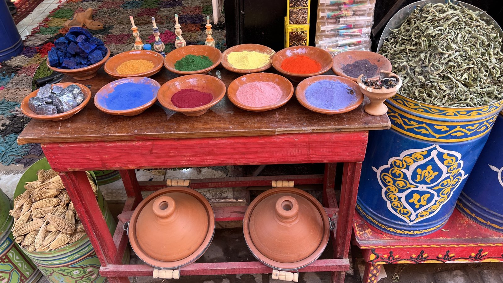 Colorful natural pigments and traditional goods displayed at Souk Semmarine in Marrakech, a popular stop for shopping during a 2 day in Marrakech itinerary.