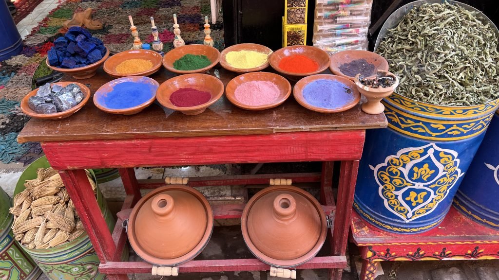 Colorful natural pigments and traditional goods displayed at Souk Semmarine in Marrakech, a popular stop for shopping during a 2 day in Marrakech itinerary.