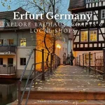 Evening view of the historic Krämerbrücke in Erfurt, Germany, featuring timber-framed buildings, autumn leaves on a wooden pedestrian bridge, and warm glowing lights from artisan shops — promoting Bauhaus design, local crafts, and handmade traditions.