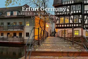 Evening view of the historic Krämerbrücke in Erfurt, Germany, featuring timber-framed buildings, autumn leaves on a wooden pedestrian bridge, and warm glowing lights from artisan shops — promoting Bauhaus design, local crafts, and handmade traditions.