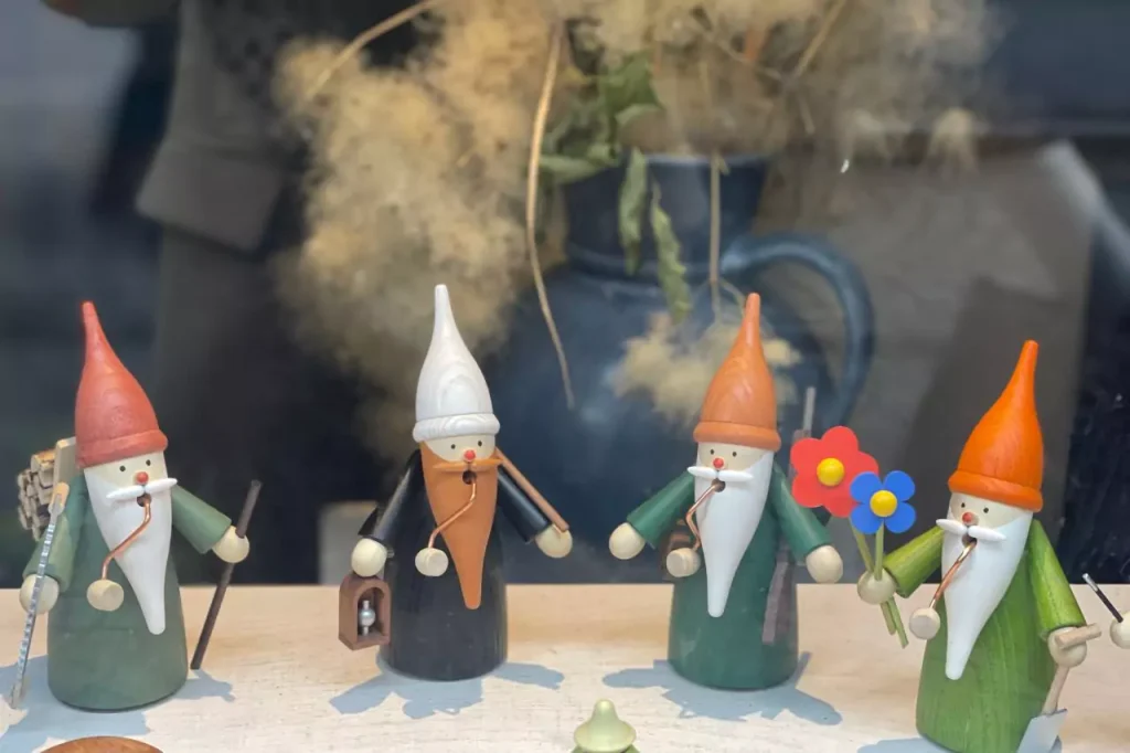 Handcrafted wooden gnome figurines displayed in the window of Martin Gobsch's puppet and marionette workshop in Erfurt, Germany