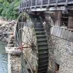 Vertical shot of the waterwheel next to a wooden structure. Branson, Missouri.
