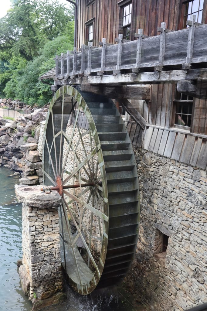 Vertical shot of the waterwheel next to a wooden structure. Branson, Missouri.
