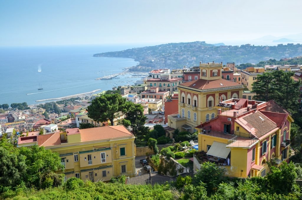 View across the bay of Naples on the coastline of Campania. Historic buildings, and marina and