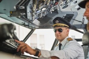 Confident pilot of the passenger plane doing his work professionally