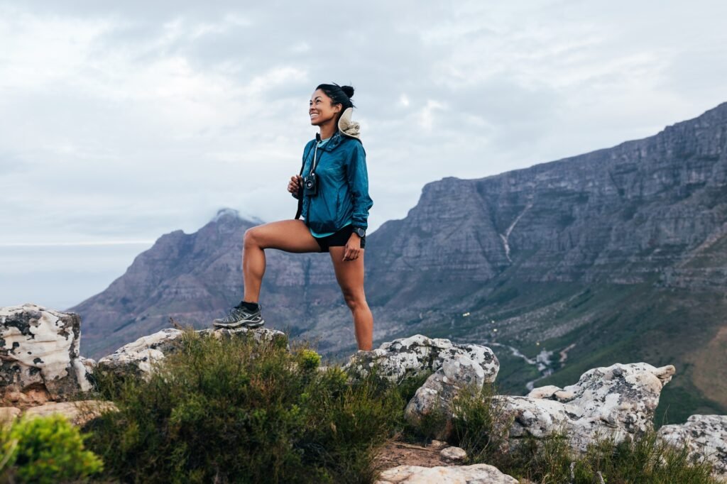 Smiling woman hiker with camera and backpack