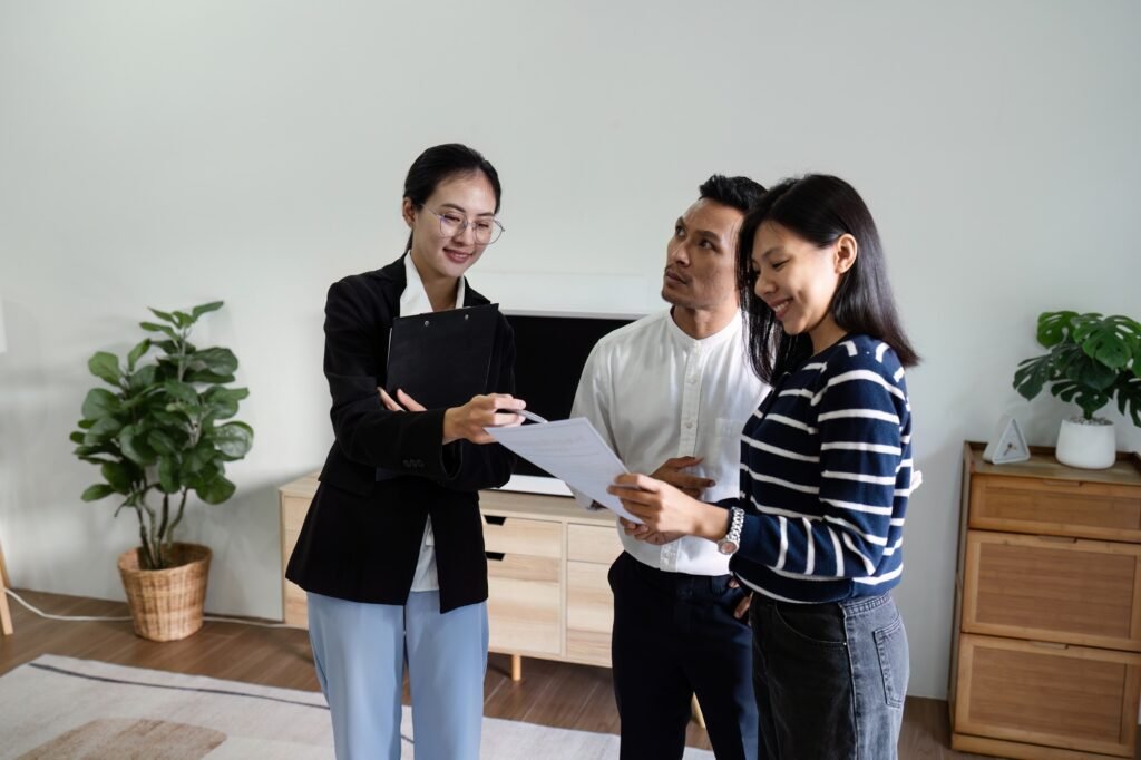 young couple with a real estate agent visiting home for buy or for rent