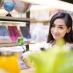 young woman buying souvenirs in gift shop
