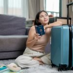 Young woman holding a United States passport and dreaming of her next trip abroad