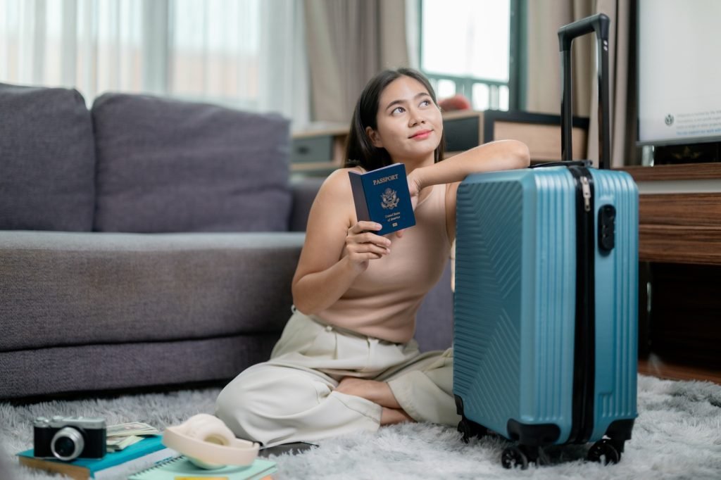 Young woman holding a United States passport and dreaming of her next trip abroad