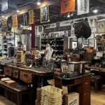 Interior of Manready Mercantile in Houston featuring rustic wooden tables, shelves of handmade goods, vintage décor, and U.S.-made products — a must-visit stop to shop like a local in Houston.