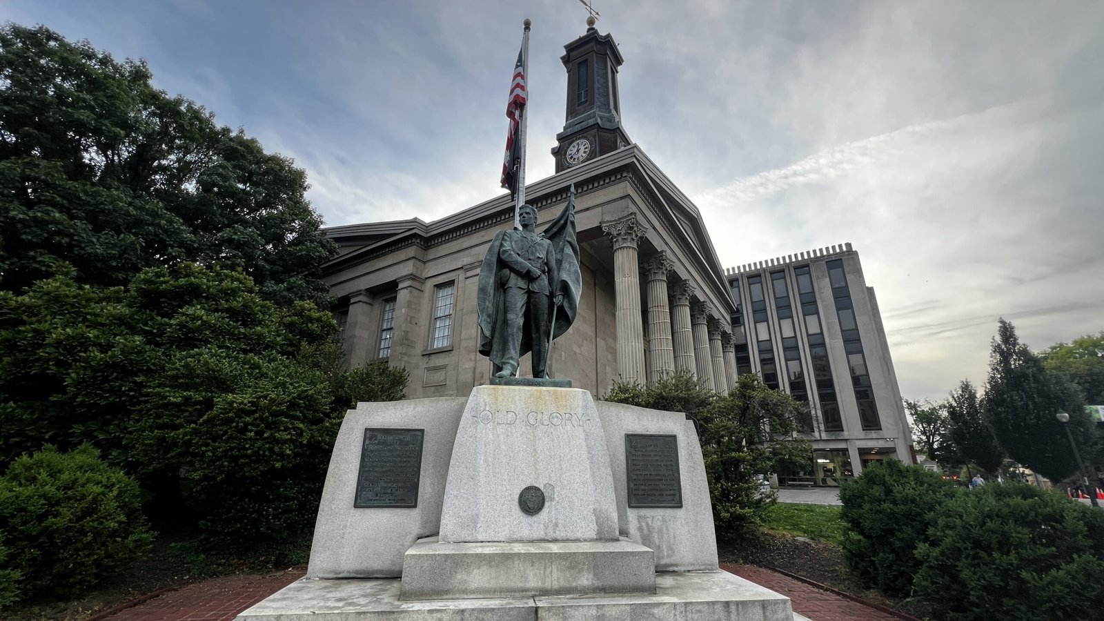 Old Glory war memorial statue with soldier figure in front of the historic courthouse in West Chester.