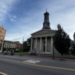 Historic downtown Harrisburg featuring the Greek Revival-style Dauphin County Courthouse with its tall clock tower, surrounded by classic buildings along the street. Top Things to Do in West Chester, Pennsylvania