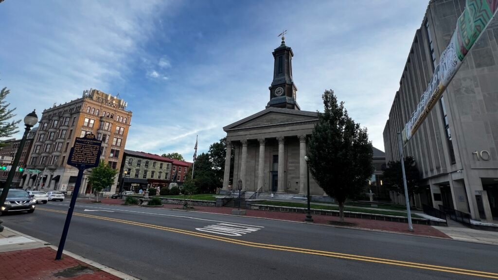Historic downtown Harrisburg featuring the Greek Revival-style Dauphin County Courthouse with its tall clock tower, surrounded by classic buildings along the street. Top Things to Do in West Chester, Pennsylvania