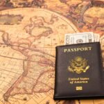 American passport next to a patriotic flag.