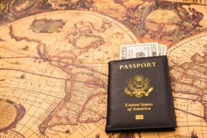 American passport next to a patriotic flag.