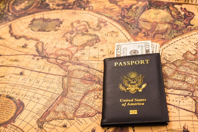 American passport next to a patriotic flag.