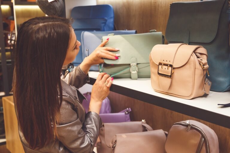 Female customer purchasing new handbag in shop