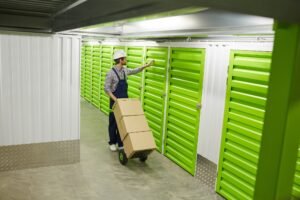 Worker with load in storage room